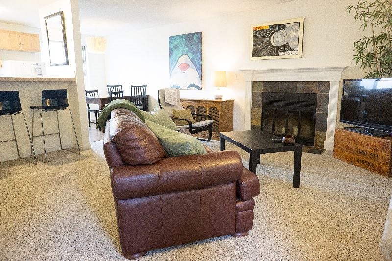 Open living/dining area with breakfast bar seating and fold out couch.