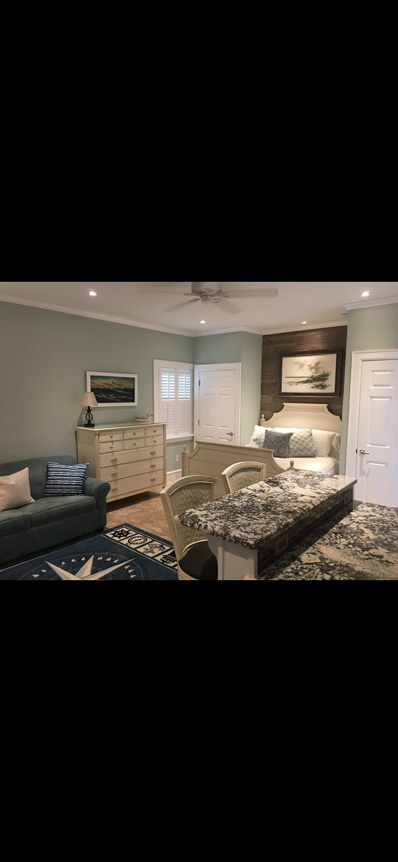 Queen bed with closet on left and washer/dryer on right