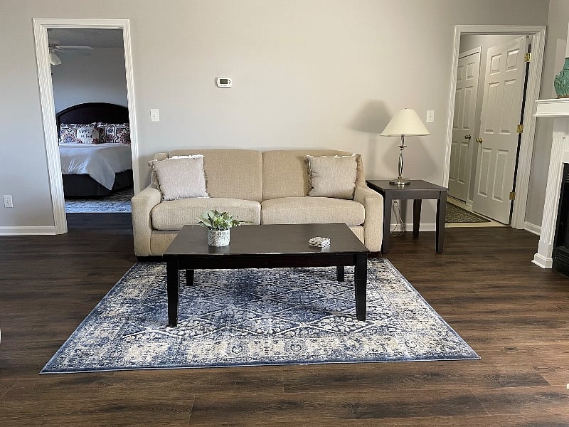 Master Bedroom left of couch. Laundry room right of couch.