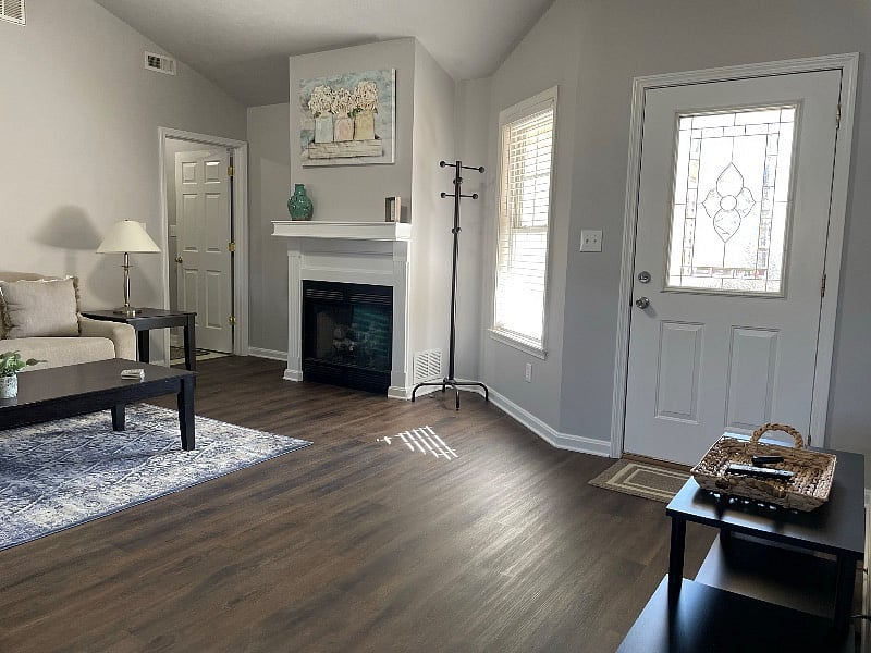 Front door opens into family room with vaulted ceiling and fireplace.