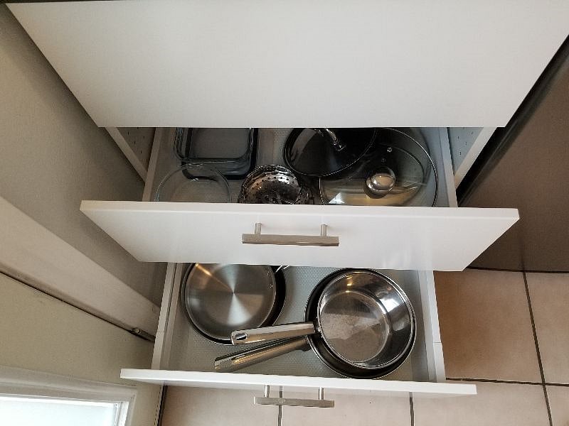 Assortment of pots, dishes, glasses, silverware, Brita water filter.