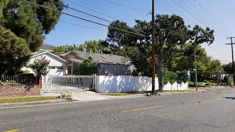 Street view of entrance to the Studio. Personal gate is left of driveway gate