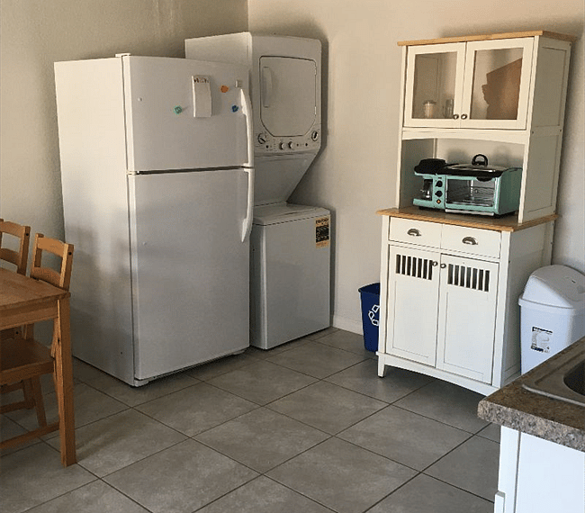 Full size fridge, stackable washer/dryer, and pantry.