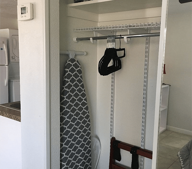 Full size iron board, iron, hangers, hamper, and luggage rack. 