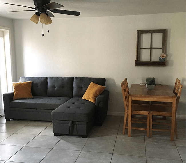 Living room space includes sofa and chaise lounger combo. Sofa can also pull out to be an additional bed space and the chaise lounge lifts up where extra pillows and blankets are stored. 