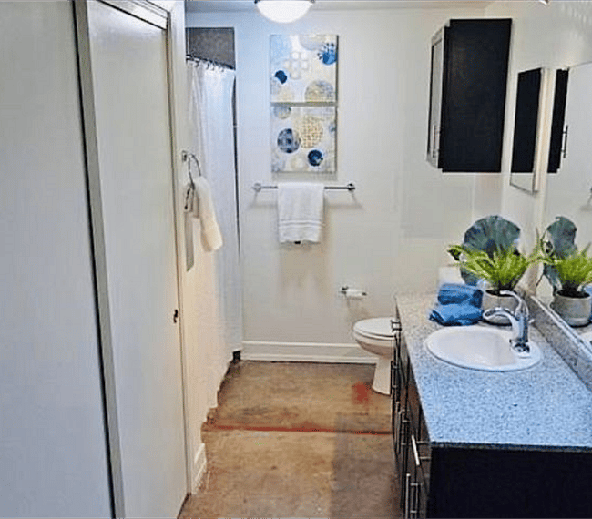 The bathroom is modern and stylish with shower, toilet and vanity
