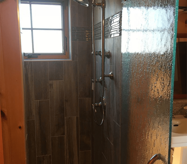 A spacious shower features attached to the master bedroom