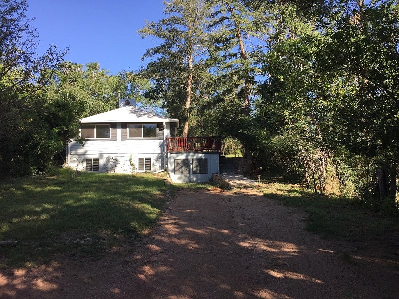 Front of the house, driveway and parking area.
