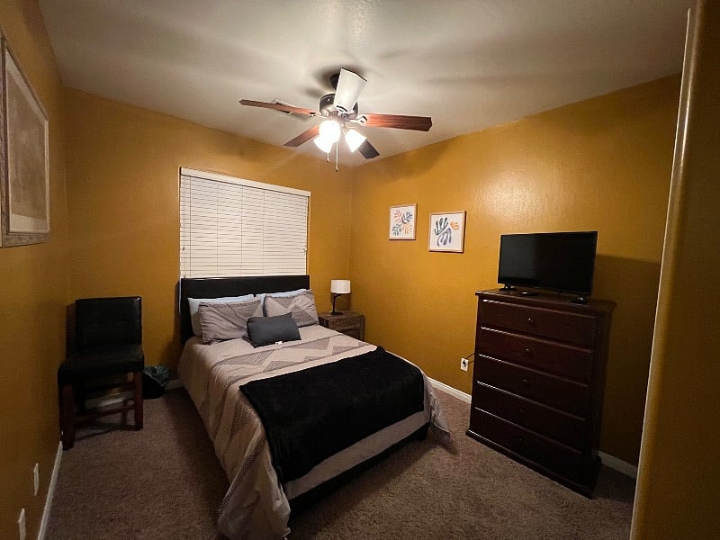 Gold room with smart tv shared bath.