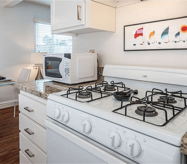 The kitchen features a full-sized stove and refrigerator, as well as everything needed to cook a great meal.