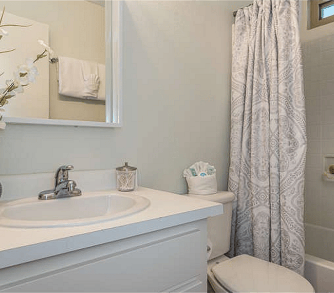 Full Bathroom with tub and shower, located at the top of the stairs near the bedrooms.