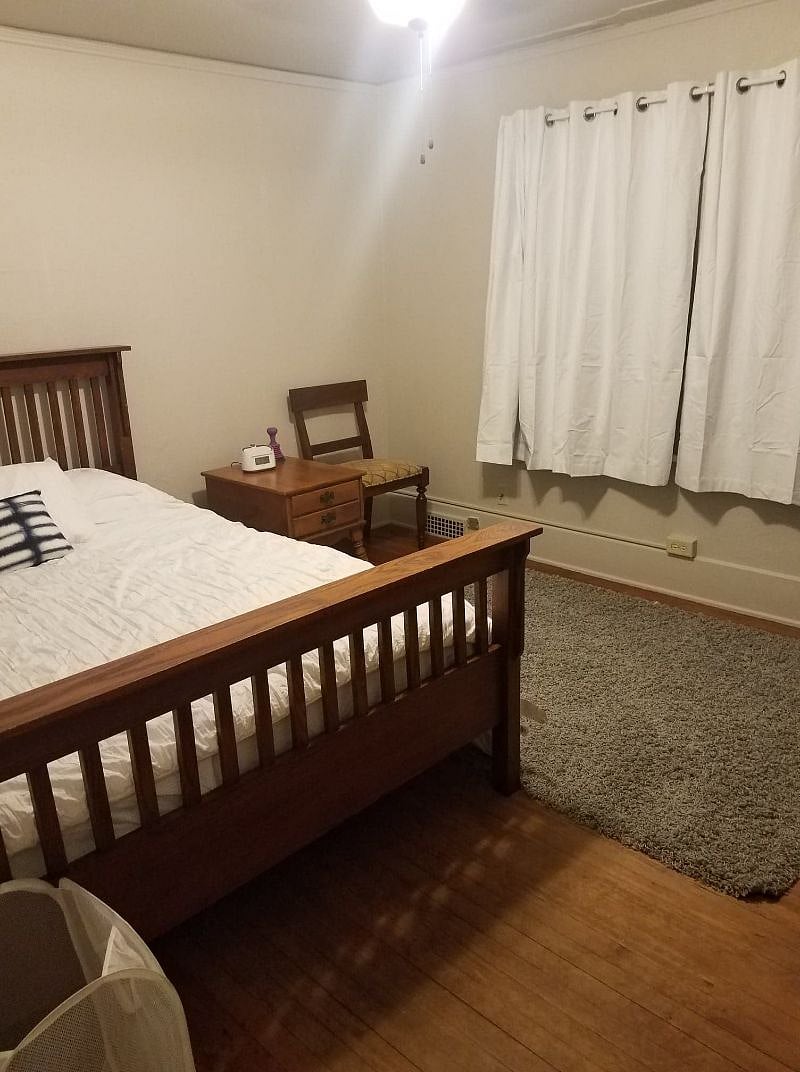 One of two bedrooms. Dresser, chair, side table, full length mirror and closet included. Blackout curtains are included. Mattress and bedding are all new.