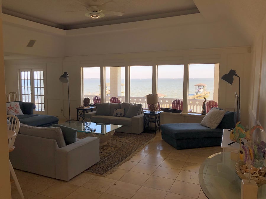 Living Room on 2nd Floor with expansive view of the bay. *Pier in background was destroyed in recent hurricane and is currently unusable.