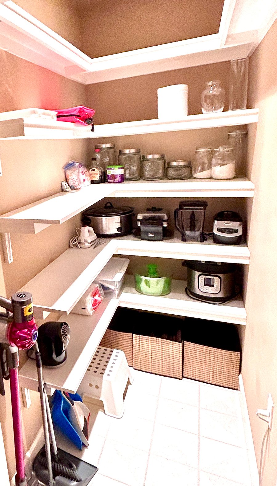 The kitchen pantry offers lots of room for food and storage. There's also a Dyson vacuum for clean ups.
