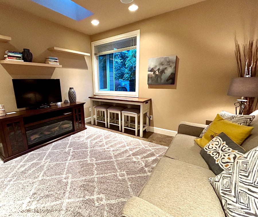 The Den offers a work space with power under the window. There is a queen size sleeper sofa, cable TV with hook ups for gaming and an electric fireplace for warmth and ambiance. A skylight brings a nice amount of daylight into the room as well.