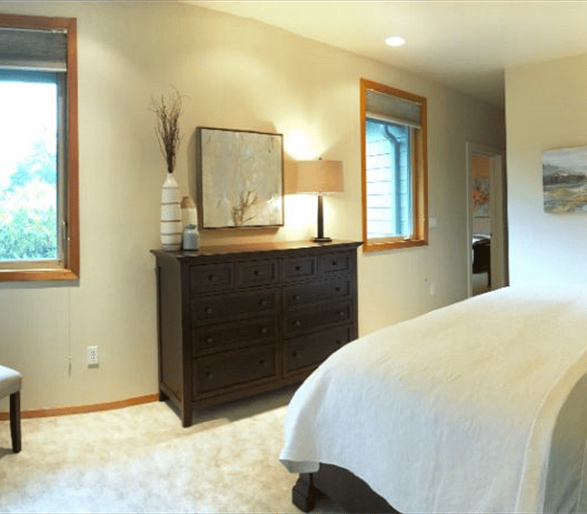 The king bedroom has a big 10 drawer dresser and large walk-in closet supplied with hangers, an extra pillow and blanket and iron and ironing board. This bedroom has an amazing amount of clothing storage! The walk-in closet is also shared with the adjoining twin room. This room is in soothing colors of aqua, taupe, cream & white a very restful and relaxing environment!