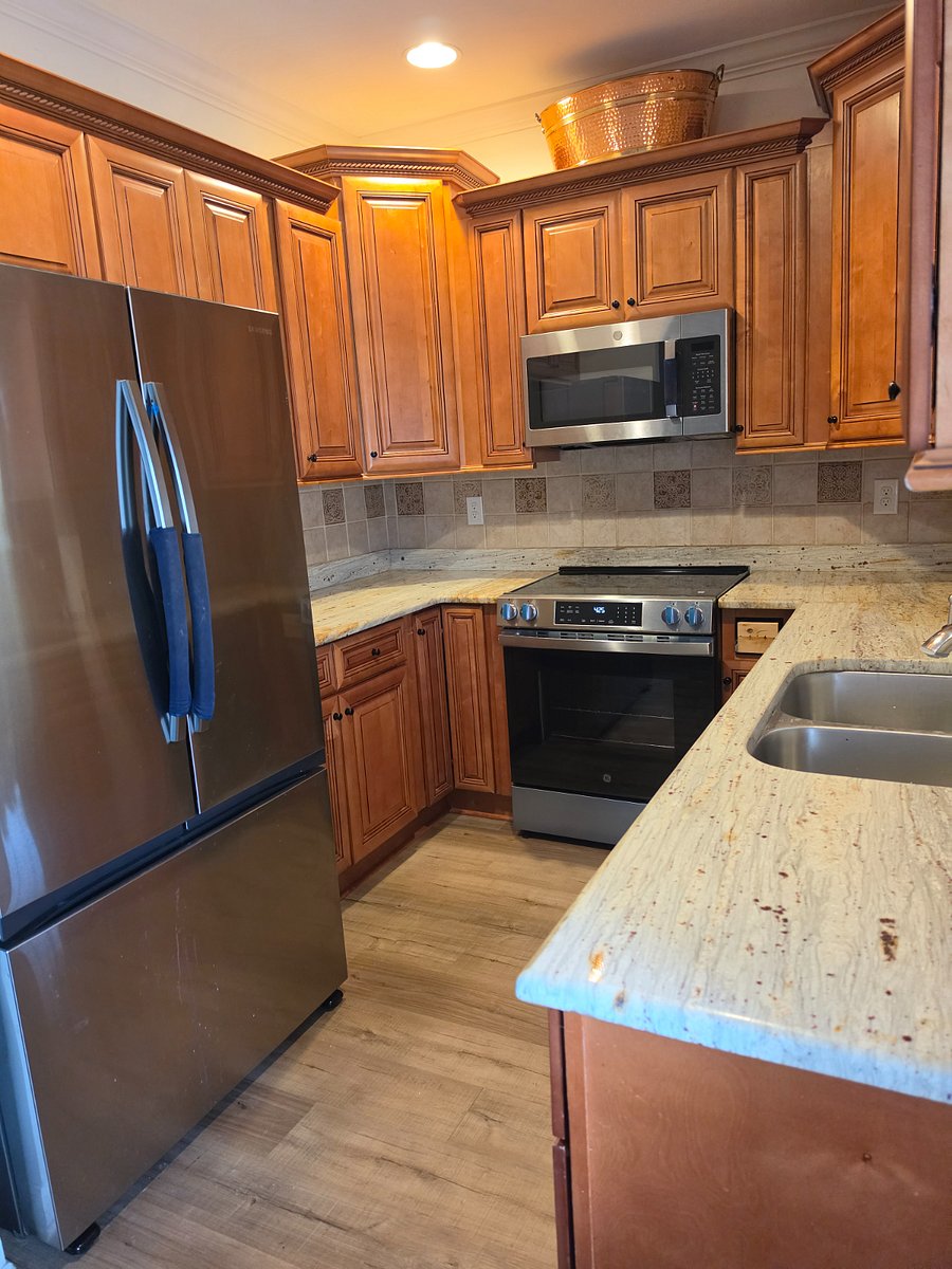 Kitchen with granite counter tops and 42" cabinets as well as a pantry.