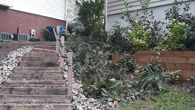 Stairs down from parking - Well lite security parking with dusk to dawn backyard security lighting