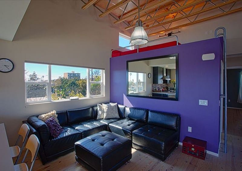 Open, spacious living room with natural light and a loft bed (in addition to the two bedrooms)