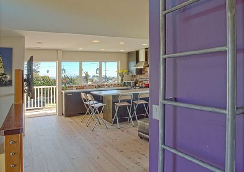 Looking towards living room and then kitchen. Laundry is to your left, next to the door that leads to your private roof deck.