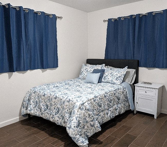 Bedroom #1 with 2 open windows, facing east, black out curtains included. Full sized bed with memory foam mattress. Ceiling fan/light.