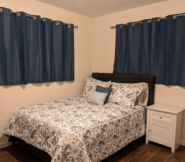 Bedroom #2 with 2 open windows, facing west, black out curtains included. Full sized bed with memory foam mattress. Ceiling fan/light