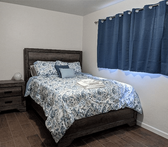 Master bedroom with big windows and blackout curtains