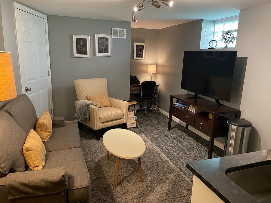 Private living space with TV, desk area and wet bar.