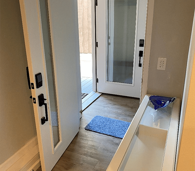 View from entryway into mudroom and the front deck