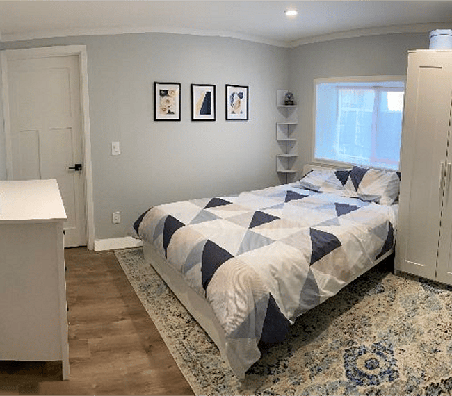 Fully furnished bedroom including linens, pillows, and towel sets