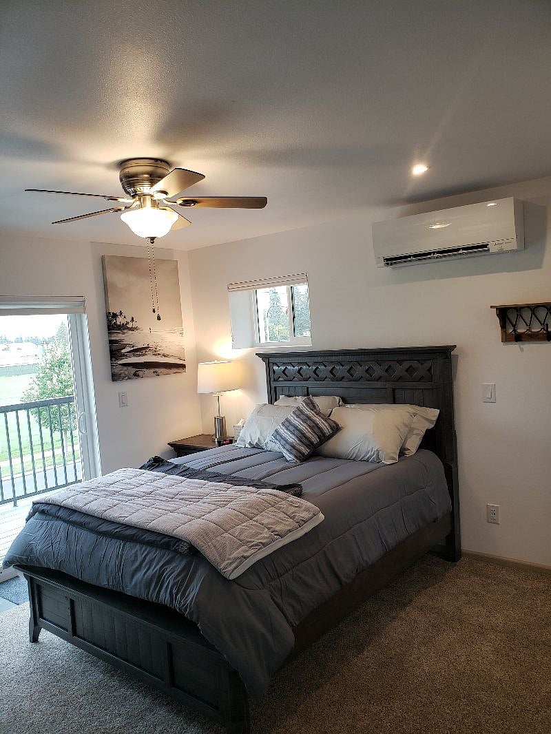 A beautiful large bedroom with a Queen bed, Large dresser, night stand, lamp, dual alarm clock & radio, heating & AC, patio slider out to your beautiful 30 foot deck. 2 x 12 walls and amazing insulation. Plus top down-bottom up blinds. Some plug-ins in the room have cell charger USB's.