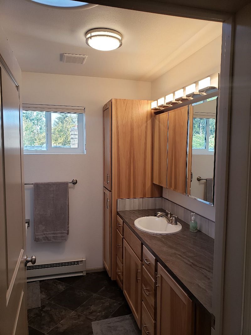 Very spacious bathroom...Another view as you are entering the bathroom. 100% privacy...plus 2 x 12 insulated walls. Special LED dimmer vanity lights as well as a regular LED light in the ceiling PLUS an amazing 24" sun tunnel-round - skylight in the ceiling for amazing natural sunlight, perfect for how you want to see yourself when getting ready in the mornings. PLUS yep, a cell phone holder on top of the TP dispenser...