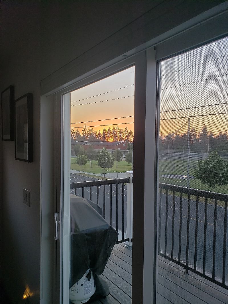 Beautiful evening SUNSET in June, looking out your living room & kitchen patio door..