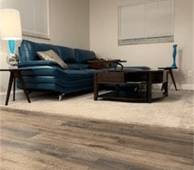 Living area with comfy couch and adjustable coffee table view from the kitchenette