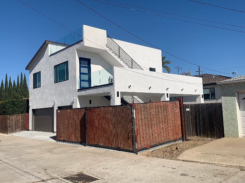 unit is above 3 car garage/ alley side view