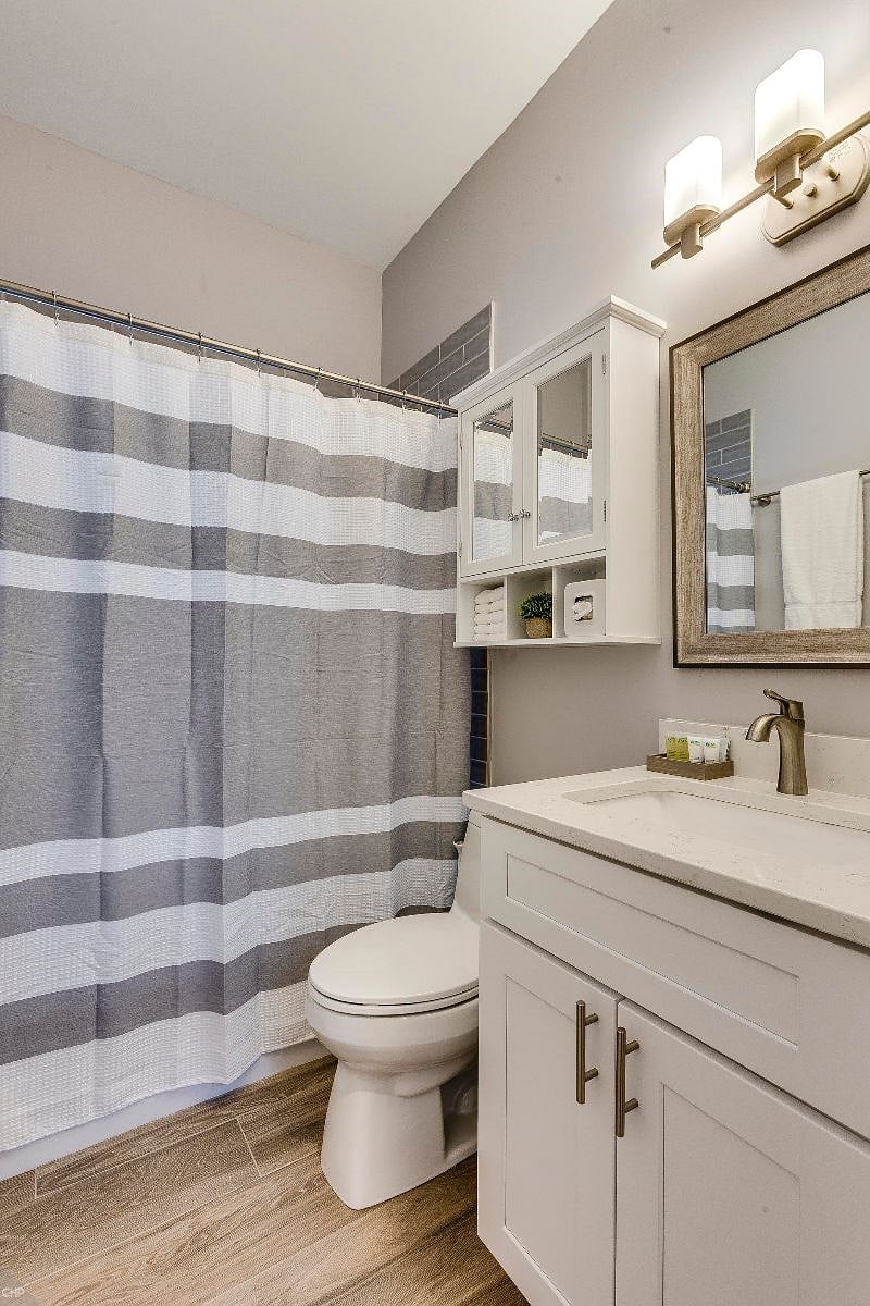 Bathroom with tub and shower. Various extra bathroom toiletries provided for your convenience.