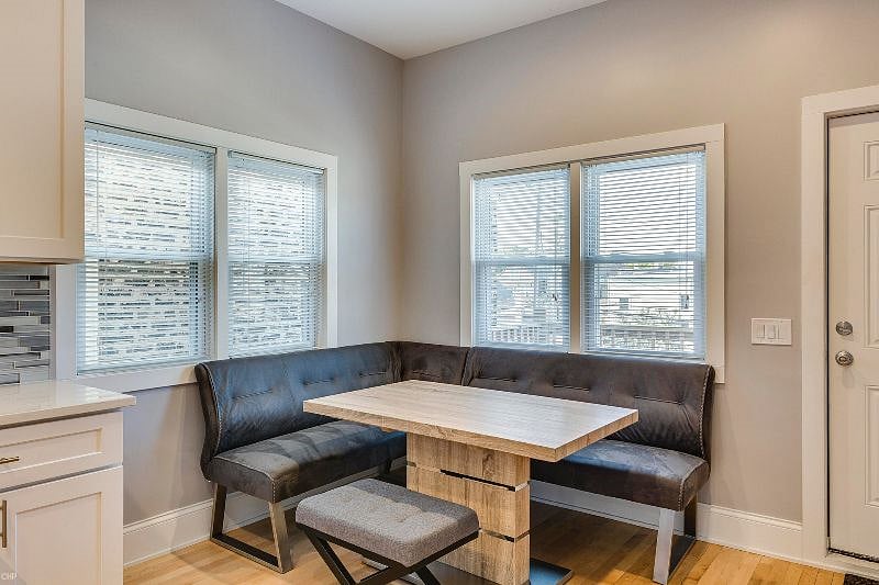 Dining table comfortably seats 4 as-is, but with expansion leaf and extra chairs, will seat 7 or more.