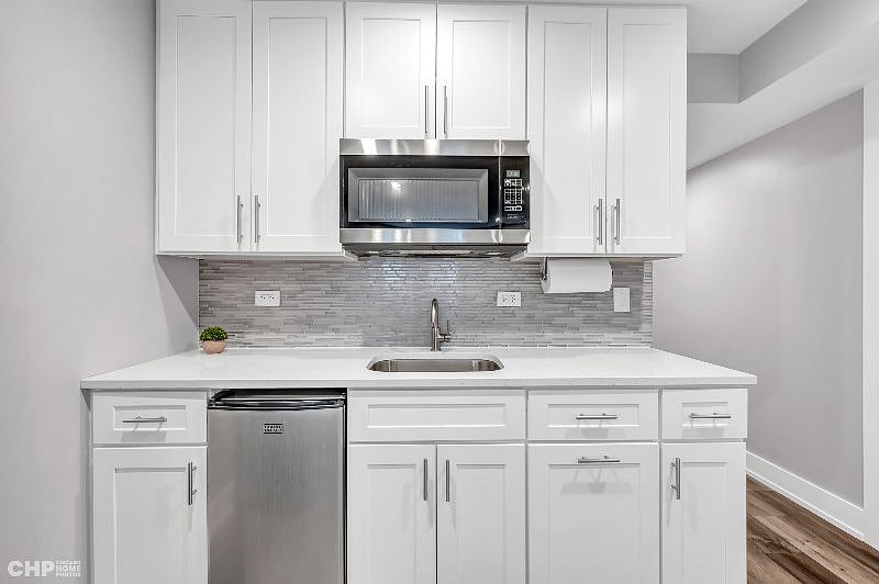Kitchenette with sink, microwave, mini-fridge, coffee maker. Basic utensils provided. Toaster oven provided, but there is no stove. Medium sized refrigerator to be provided in addition to mini-fridge for additional refrigerator space.