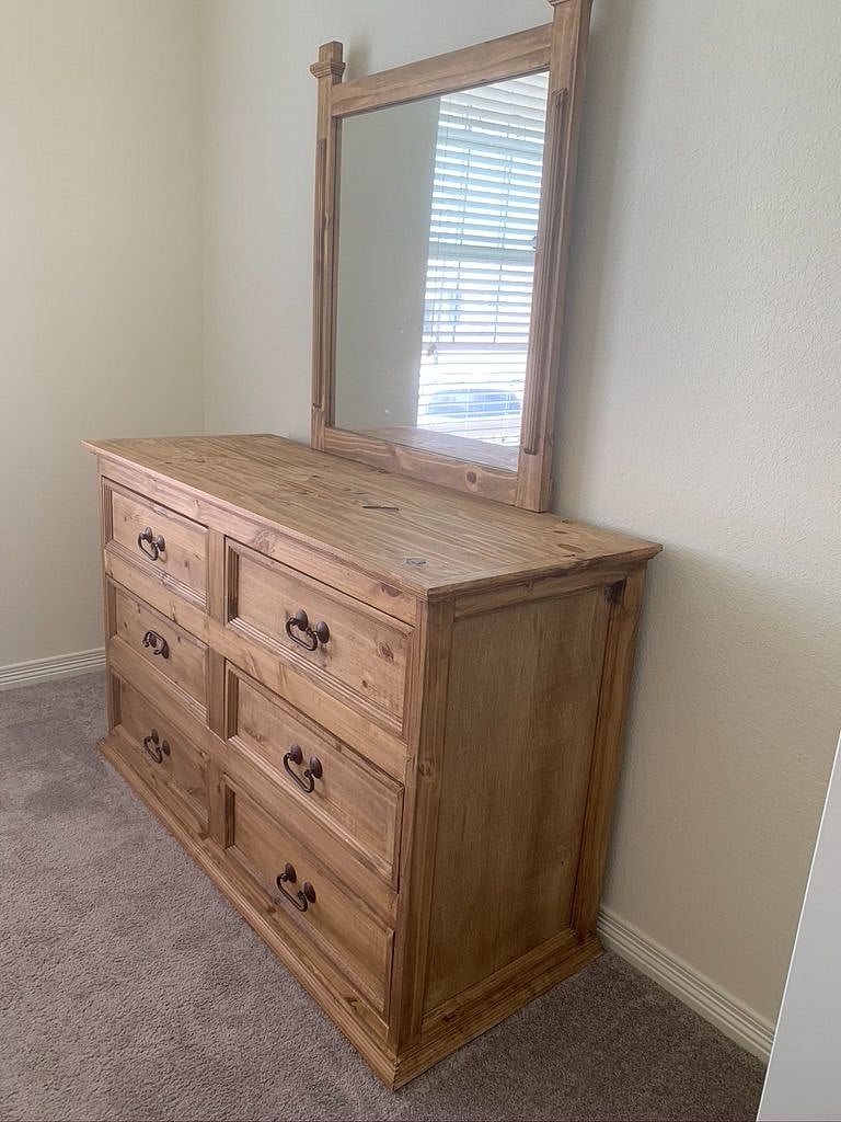 Dresser located in the bedroom