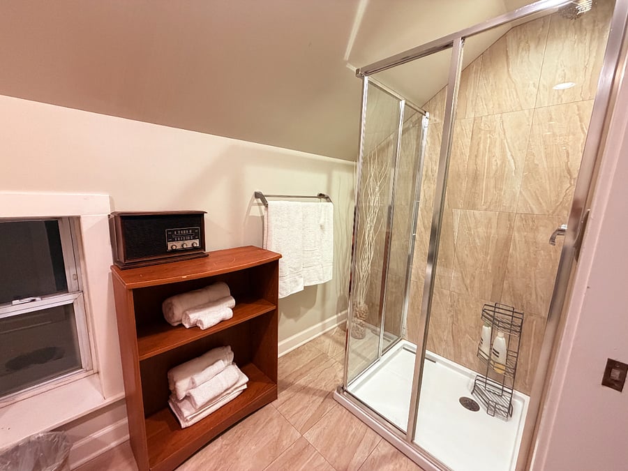 Modern bathroom with a refreshing shower, soft fresh linens, and all the essentials for a comfortable stay.