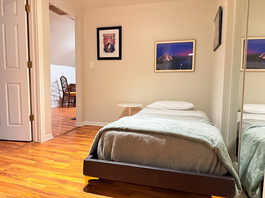 A clean, comfortable bed with fresh linens with direct access to the dining area.