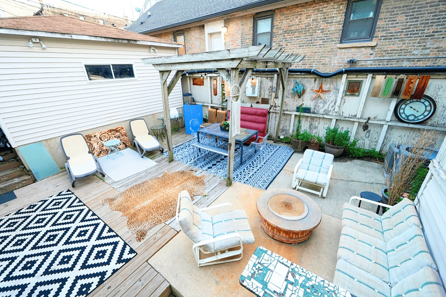 Unwind on the shared backyard patio with lots of seating, perfect for relaxing and enjoying the serene outdoor atmosphere.
