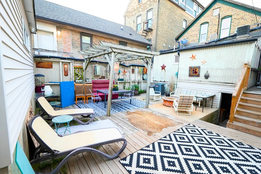 Unwind on the shared backyard patio with lots of seating, perfect for relaxing and enjoying the serene outdoor atmosphere.