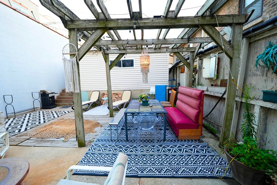 Unwind on the shared backyard patio with lots of seating, perfect for relaxing and enjoying the serene outdoor atmosphere.