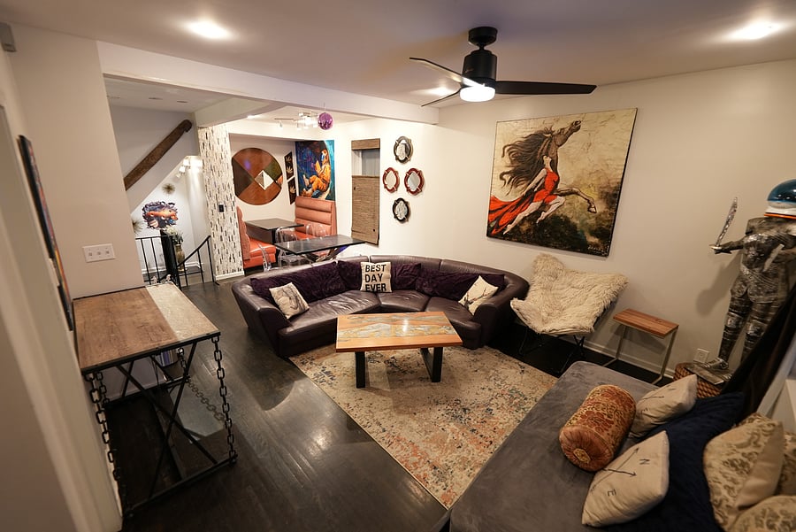 Unwind in a cozy living space with vibrant decor, Smart TV, a comfortable sectional and plenty of natural light. Ideal for relaxing or entertaining