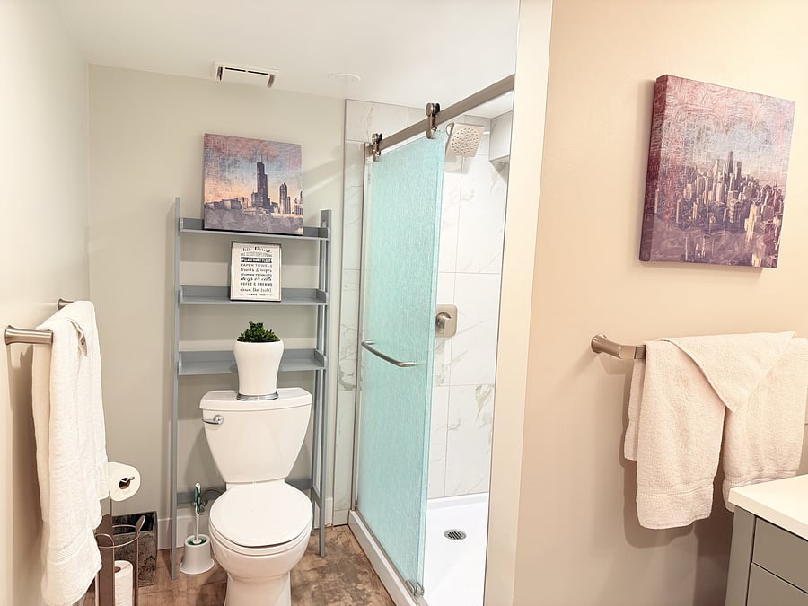 Enjoy a relaxing, bright, and modern bathroom featuring a stylish vanity, fresh towels, and essential amenities in a clean, spacious layout. Perfect for starting and ending your day in comfort.