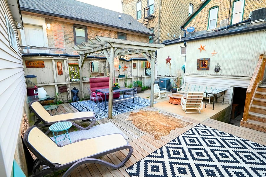 Shared backyard patio with lots of seating, perfect for relaxing and enjoying the serene outdoor atmosphere.