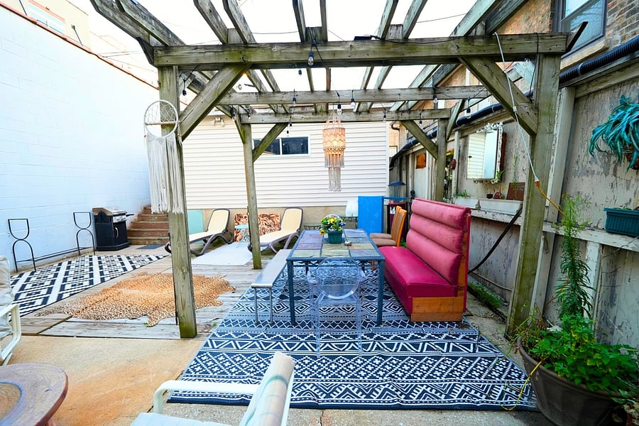Shared backyard patio with lots of seating, perfect for relaxing and enjoying the serene outdoor atmosphere.