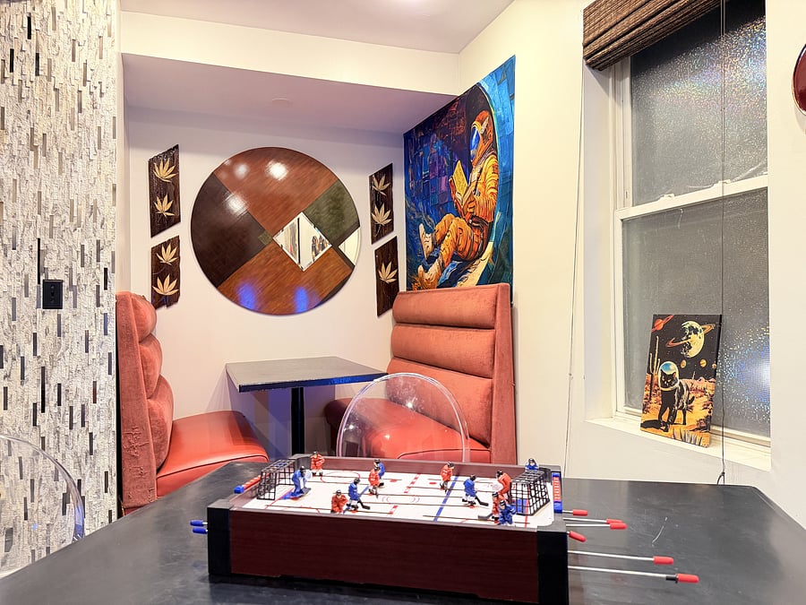 A cozy dining nook with comfortable booth seating, contemporary accents, and bold artwork. An inviting spot for meals, coffee, or conversation.
Enjoy a tabletop game setup for relaxed dining and some friendly competition.