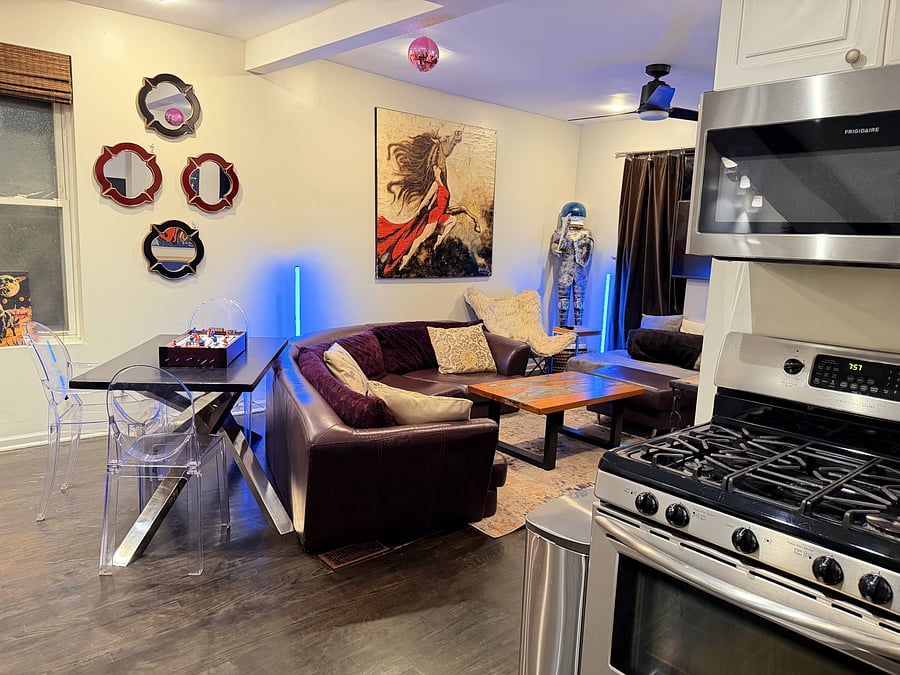 Open-concept living with modern lighting, and unique art pieces, all just steps from a fully equipped kitchen.